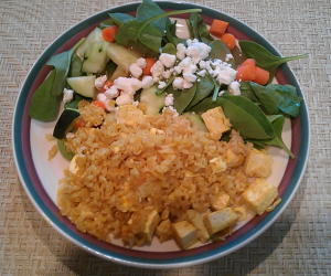 Good recovery meal of brown rice and tofu seasoned with turmeric and a salad.