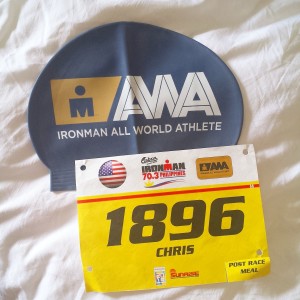 Chris of Team NEO and his IRONMAN 70.3 Philippines bib and race cap.