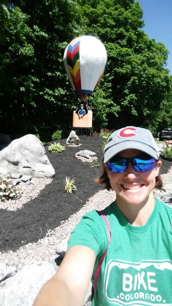  Photo of Coach Nicole in front of a hot air balloon sculpture at Jamesville Reservoir.