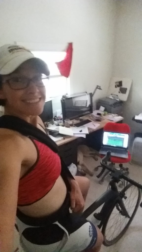 Coach Nicole on her indoor trainer (Wahoo KICKR) to keep some cycling fitness while she can’t swim, run, or ride outside.