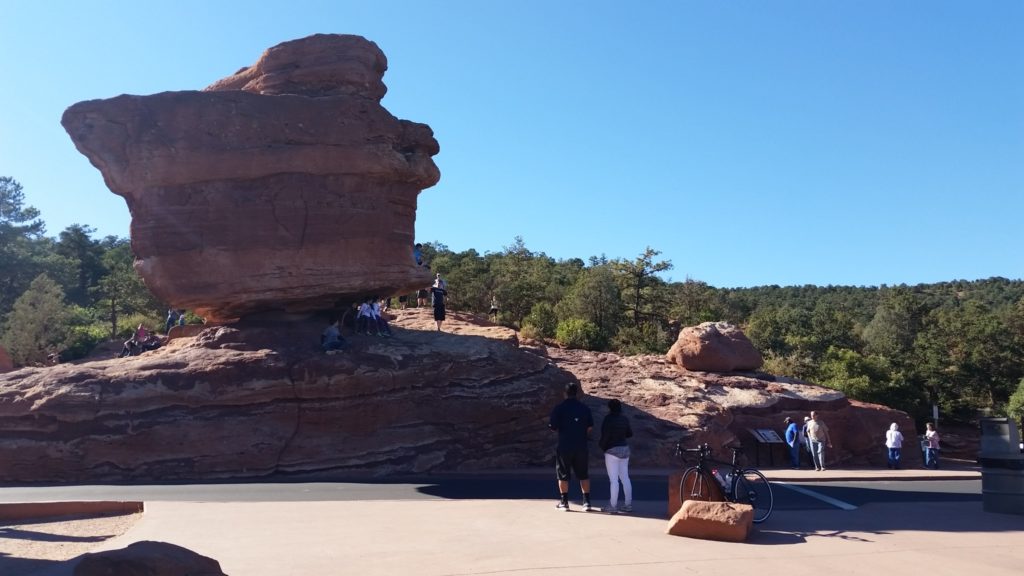 Coach Nicole, her bike, and a bunch of tourists at Balanced Rock in Garden of the Gods, Colorado Springs, CO.