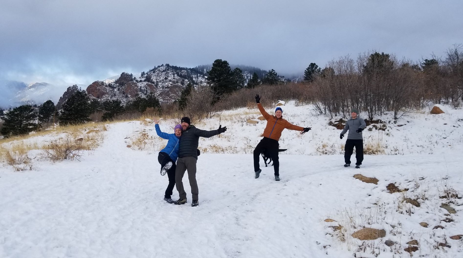 people with open arms in the snow