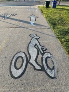 a painted bike path marking with a ram on a bicyle.